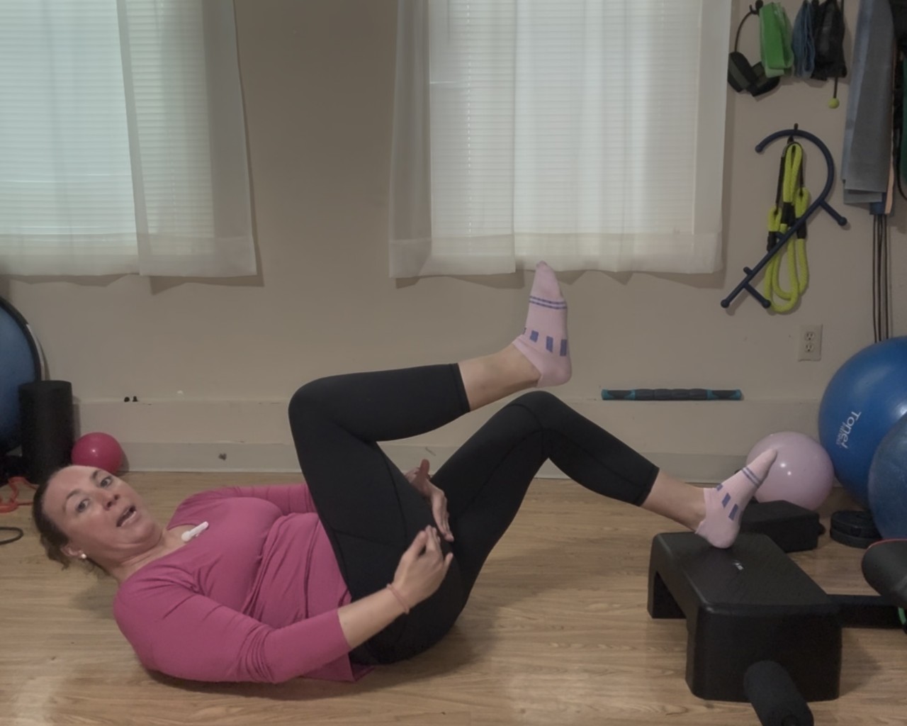 Women lying on her back holding her hamstring